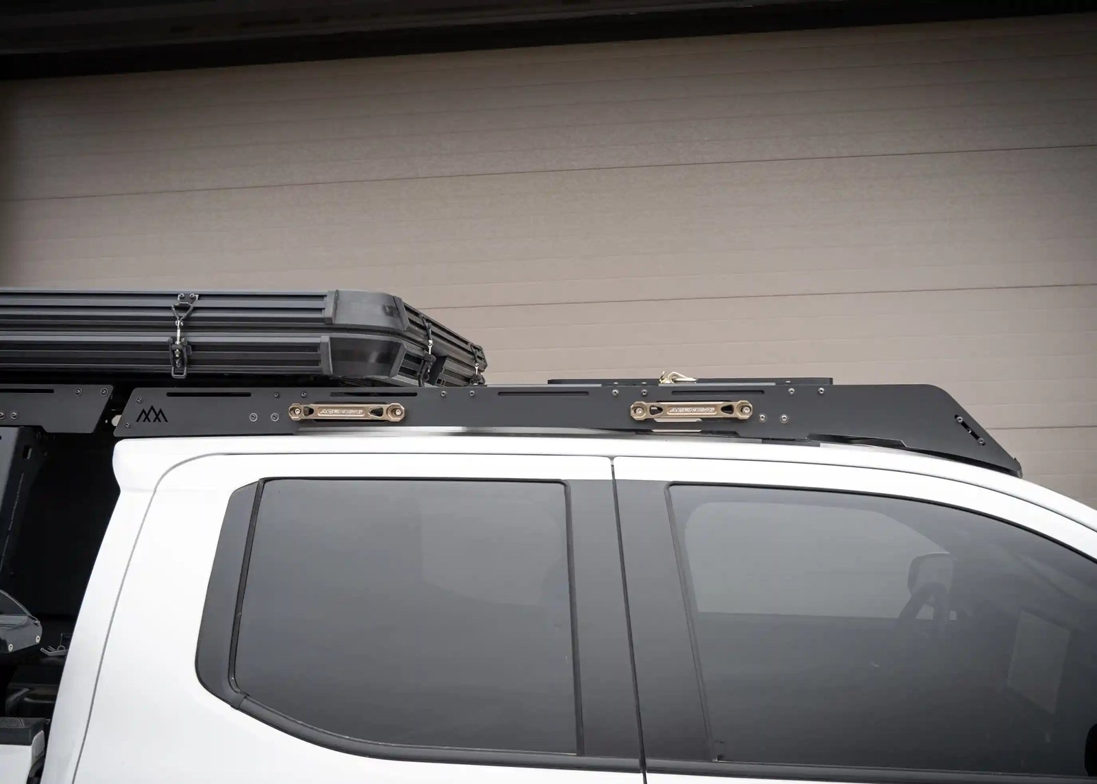Backwoods DRIFTR low-profile aluminum roof rack mounted on a white 2024 Toyota Tacoma Double Cab